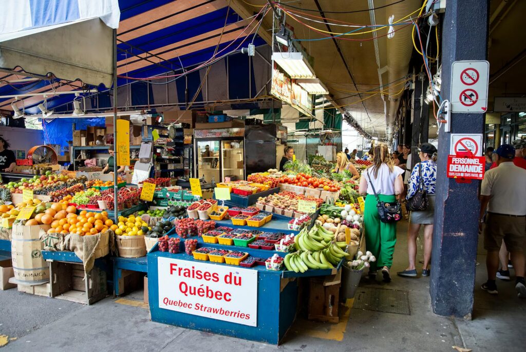 Explore a bustling street market in Quebec City showcasing fresh fruits and vegetables.